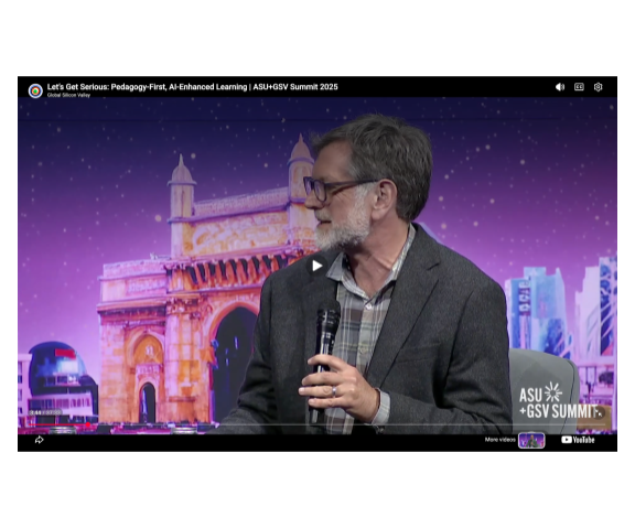 Screen capture of a man holding a microphone on the ASU-GSV stage